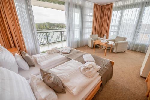 莫哈奇Szent János Hotel的一间卧室配有一张大床和毛巾