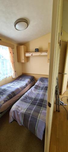 西卢港Willerby Calypso的客房设有两张床和窗户。