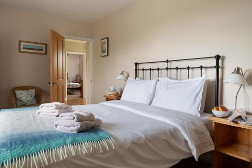 凯尼尔沃思Chase Lodge, Kenilworth, Family Sized Cottage With free Wifi的一间卧室配有带毛巾的床