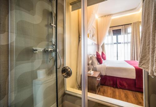 RuiruVerona Hotel and Conference Center的带淋浴的浴室和1间带1张床的卧室