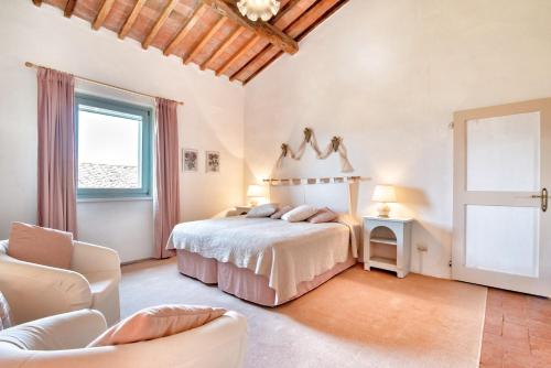 圣吉米纳诺Appartamenti Villa La Fonte的一间大卧室,配有一张床和一把椅子