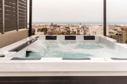 基萨莫斯Sapphire Horizon Suites的享有城市美景的按摩浴缸