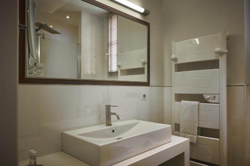 Creissels克雷塞尔城堡酒店的白色的浴室设有水槽和镜子