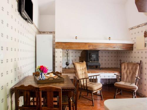 新蒙特莫尔卡萨达菲盖拉农家乐的一间设有桌子和两把椅子以及壁炉的客房