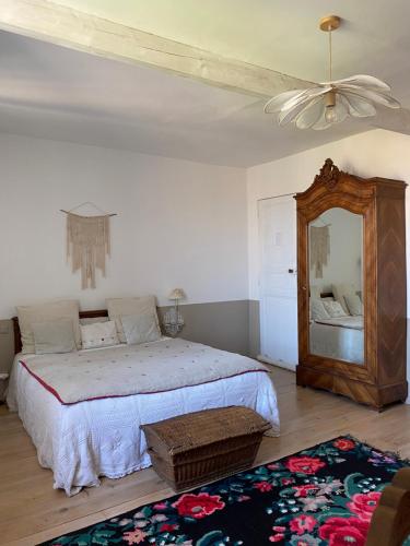 CoursanLe logis blanc bed&breakfast的一间卧室配有一张大床和镜子