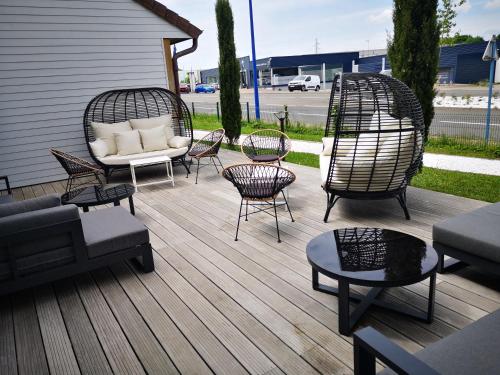 蒙索莱米讷Le Konine - Hotel & Bar & Restaurant的庭院设有藤椅、沙发和桌子
