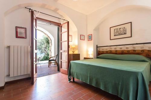莱切省卡斯特罗Il Posto delle Fragole的一间卧室设有绿色的床和开放式门。