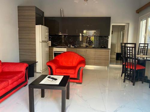 雅典luxury apartment 11' from Athens center的一间带红色家具的客厅和一间厨房