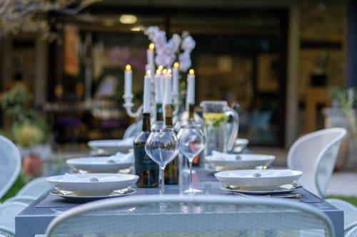 旧扎戈拉VILLA YANA Hotel Winery&Spa的一张桌子,上面放着蜡烛和酒杯