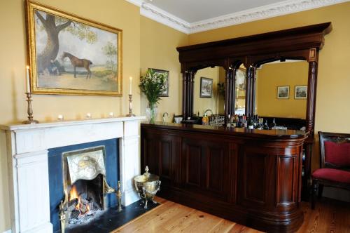 达罗阿斯布鲁克阿姆斯联排别墅餐厅旅馆的客厅设有壁炉和马的照片