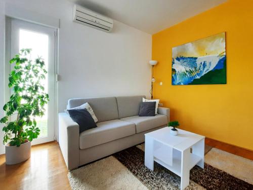 乌马格Apartment Violetta-Punta的客厅配有沙发和桌子