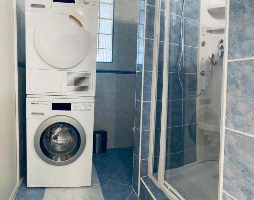 科马尔诺Apartmán Lara的带淋浴的浴室内的洗衣机