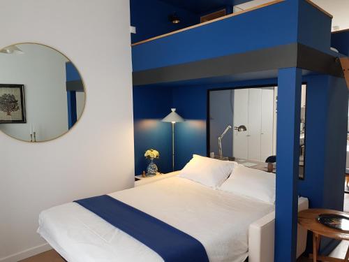 布雷斯特Brest : Beau T1 en centre ville的卧室配有一张带镜子的蓝色和白色床