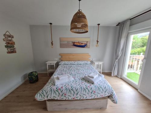 巴罗德亚尼斯Apartamento frente a la playa con vistas al mar en Barro, Llanes的一间卧室配有一张床,上面有两条毛巾