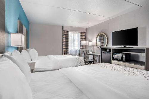 BrewtonBest Western Brewton Inn的酒店客房设有两张床和一台平面电视。