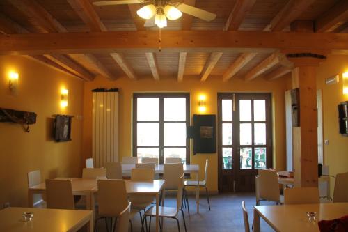 Triollo库拉瓦卡旅馆的用餐室设有桌椅和窗户。