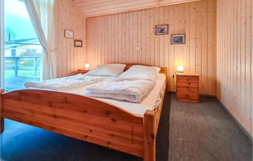 雷希林Nice Home In Rechlin With Sauna的一间带木床的卧室,位于带窗户的房间内
