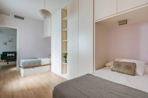 塞维利亚Luz de Sevilla Free parking的一间拥有白色墙壁的卧室和一张位于客房内的床