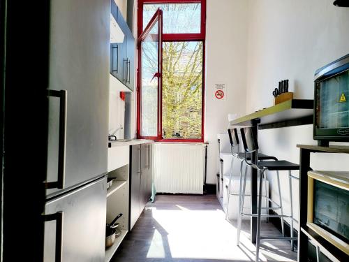 沙勒罗瓦Private Room in center of Charleroi的厨房设有窗户和电视。
