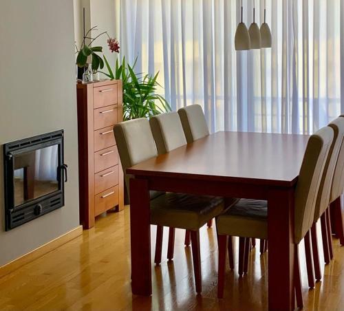 蓬塔德尔加达Yellow Five Apartment的餐桌、椅子和电视