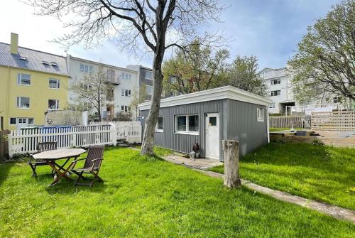 雷克雅未克Charming cottage in downtown Reykjavik - Birta Rentals的院子里的小棚子,带野餐桌