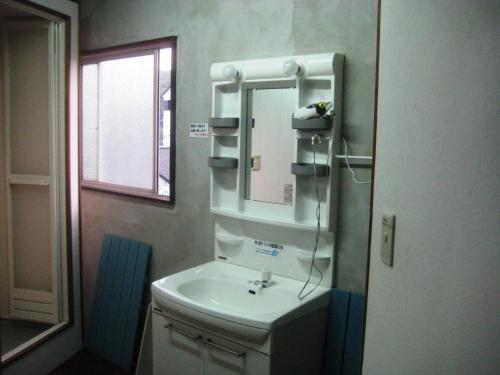 屋久岛愉凯纳卡玛塔奇旅馆的一间带水槽和镜子的浴室