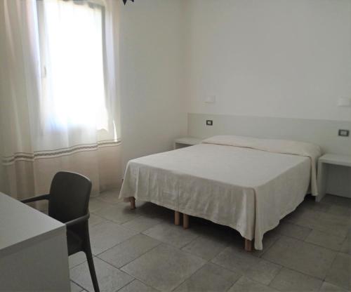 洛特佐拉伊B&B da Rosella的卧室配有床、椅子和窗户。