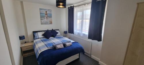 MiltonShirely S, Milton, Cambridge, 2BR House, Newly Refurbished的卧室配有蓝色和白色的床,设有窗户