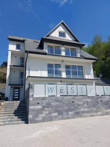 克雷尼察Westa Apartamenty的墙上有标志的白色房子