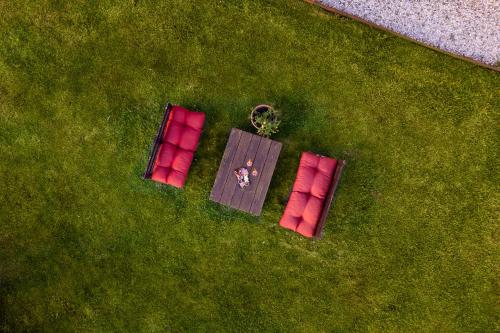 佩拉戈Tenuta Risalpiano的两把红色的椅子和一张桌子在草地上