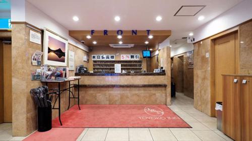 札幌Toyoko Inn Hokkaido Sapporo-eki Nishi-guchi Hokudai Mae的一间设有酒吧的餐厅,铺有红色地毯