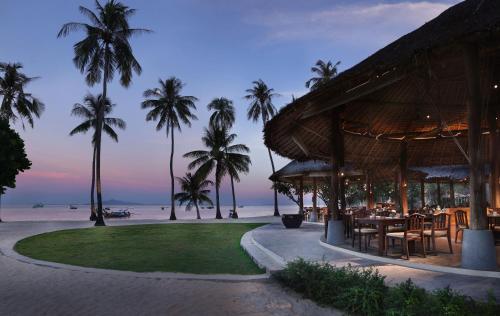 皮皮岛SAii Phi Phi Island Village的棕榈树海滩上的餐厅