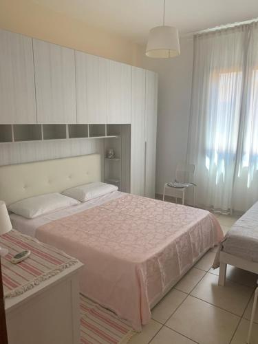 加利波利Residence Massilor的一间卧室配有一张带粉色毯子的大床