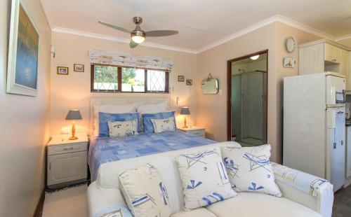 滨海肯顿Dunwerkin Bachelor Flat的一间卧室配有一张带蓝色和白色枕头的床