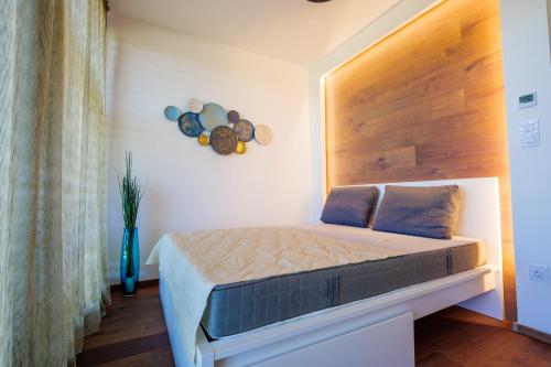 下厄尔什Club Panorama Residence的一间卧室配有一张带木制床头板的床