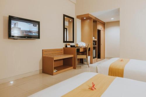 丹戎槟榔舒适酒店客房内的一张或多张床位