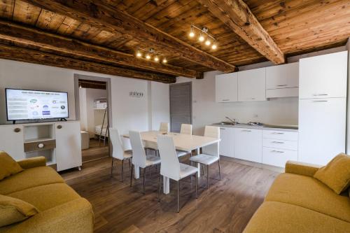 马莱斯科Residence Il Muretto的厨房以及带桌椅的用餐室。