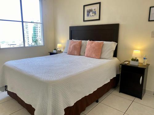 圣萨尔瓦多Luxury Modrn Apartment, w/amazing view, 3BR,Escalon,Exclus,Secur的一间卧室配有一张大床和两盏灯。