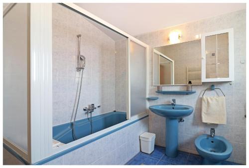 普利莫顿Kuća za odmor Angelina的浴室配有蓝色水槽和淋浴。