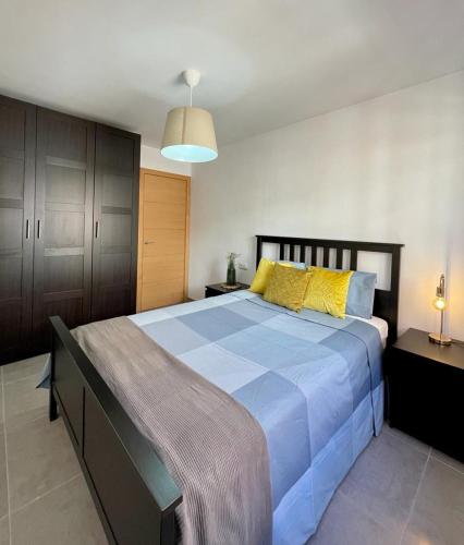 波多黎多德萨贡托UIM Mediterraneo Alicante Wifi的一间卧室配有一张带黄色枕头的大型蓝色床