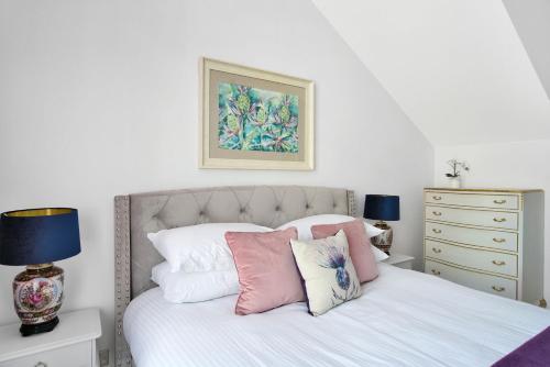 阿洛厄Craig Leith Apartment的一间卧室配有带白色床单和枕头的床。