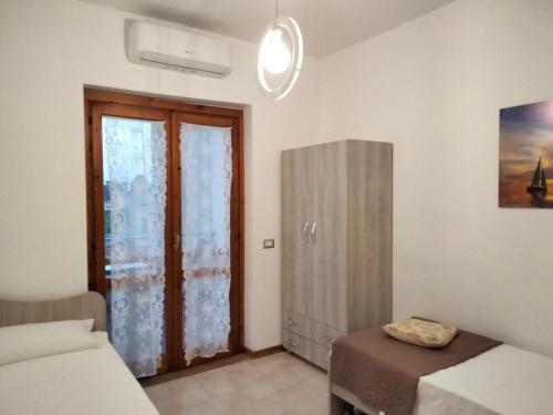 圣尼科拉阿尔切拉Villetta Clorinda的一间卧室设有一张床和一个滑动玻璃门