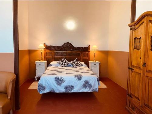 马斯诺Masia La Bomba的一间卧室配有一张带2个床头柜的大床