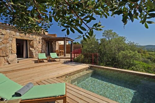 孔卡Bergeries de charme Caselle di Conca的一个带游泳池和房子的木甲板