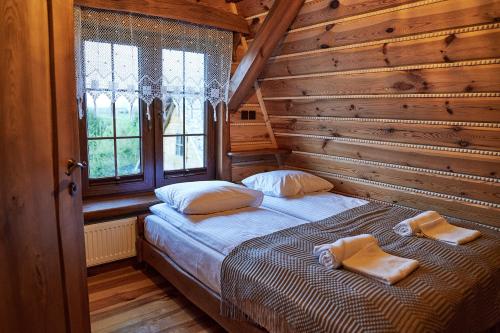 PuńskSiedlisko Sodyba的小木屋内一间卧室,配有一张床
