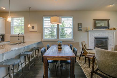 洋滨市Starfish Cottage - Oyhut Bay Seaside Village的厨房以及带桌子和壁炉的用餐室。