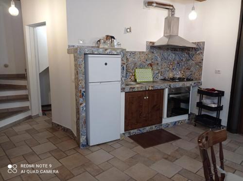 维托尔基亚诺Casa Angelene的厨房配有白色冰箱和炉灶。