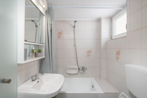 海若克利欧Rooftop Cosy Apartment Perfect Location的白色的浴室设有水槽和淋浴。