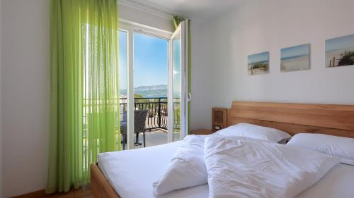 希洛Cool Šilo Appartement Resort的一间卧室设有一张床和一个美景阳台
