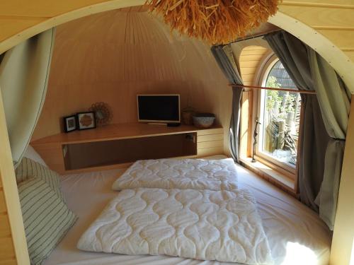 卡兰茨奥赫De Hut, in Natuurgebied en vlakbij het Strand的一间卧室设有一张床和一个窗口